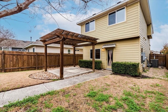 rear view of property with central AC, a pergola, and a patio