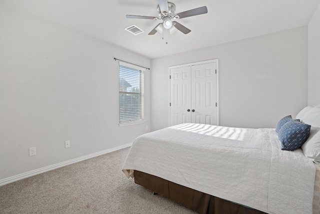 carpeted bedroom featuring ceiling fan and a closet