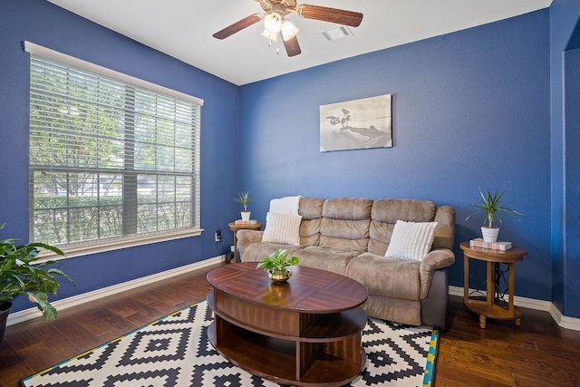 living room featuring dark hardwood / wood-style floors and ceiling fan