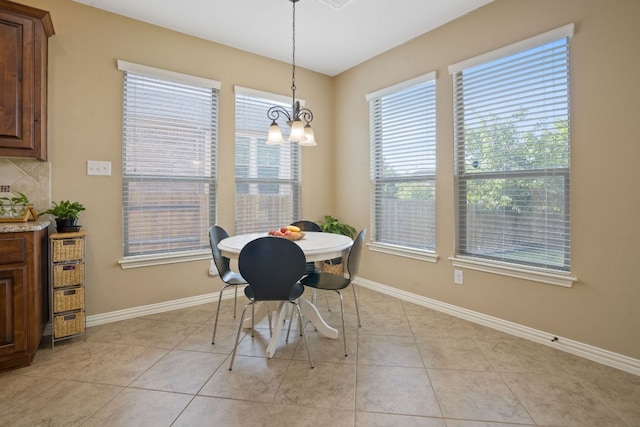 dining space featuring light tile patterned floors and a chandelier