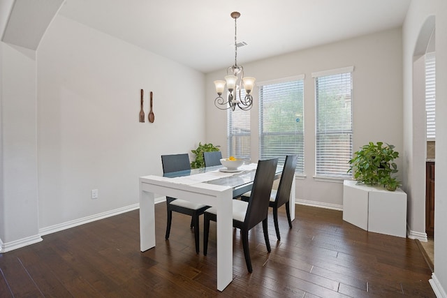 dining room featuring dark hardwood / wood-style floors and a chandelier