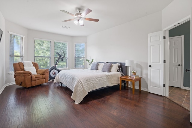 bedroom with ceiling fan and dark hardwood / wood-style flooring