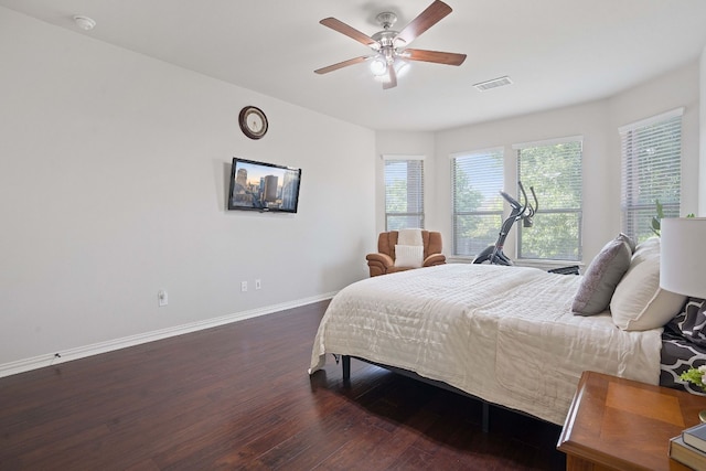 bedroom with ceiling fan and dark hardwood / wood-style flooring