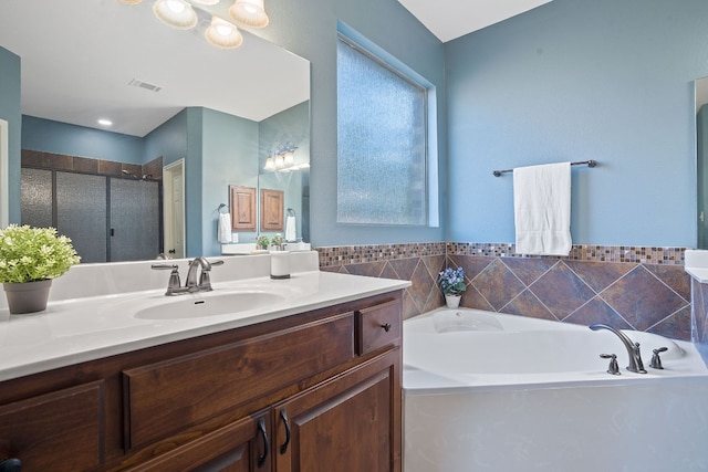 bathroom featuring a notable chandelier, plus walk in shower, and vanity