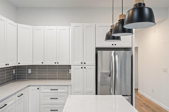 kitchen featuring white cabinetry, light wood-style flooring, and stainless steel fridge