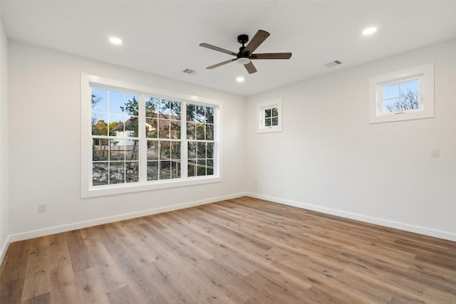 empty room with recessed lighting, visible vents, baseboards, and wood finished floors