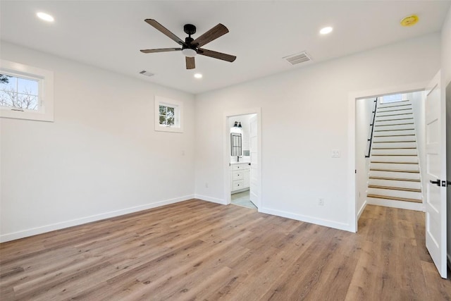 unfurnished bedroom featuring light wood-style flooring, baseboards, and visible vents