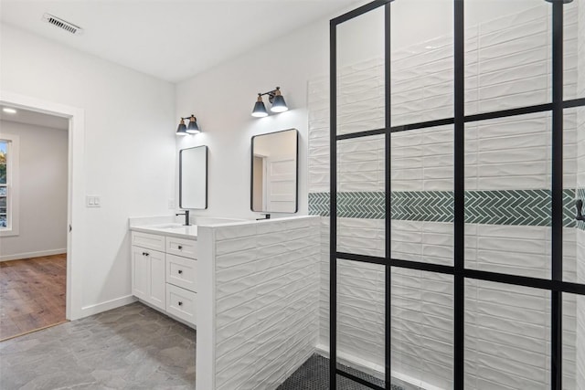 bathroom with visible vents, baseboards, and vanity