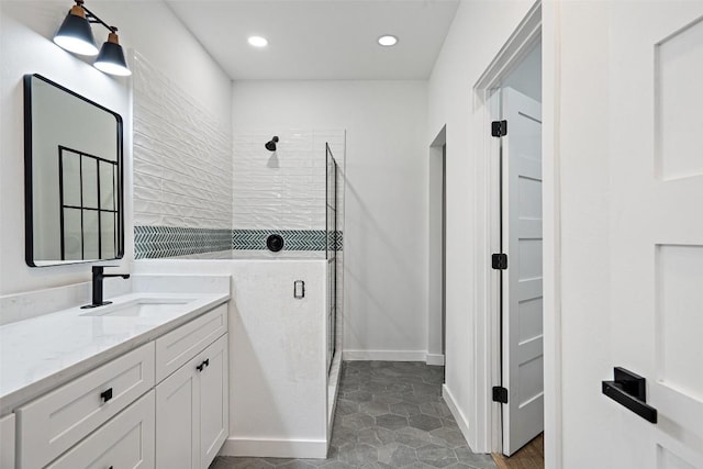 full bath featuring vanity, a shower stall, recessed lighting, and baseboards