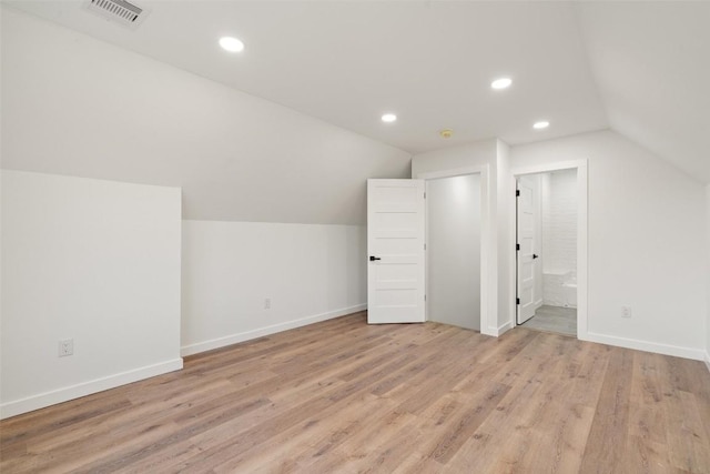 additional living space featuring visible vents, light wood-style flooring, recessed lighting, baseboards, and lofted ceiling