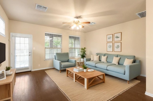 living room with dark wood-type flooring and ceiling fan