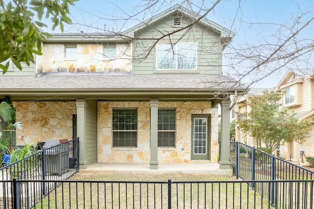 rear view of property with covered porch