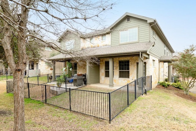 rear view of property featuring a lawn