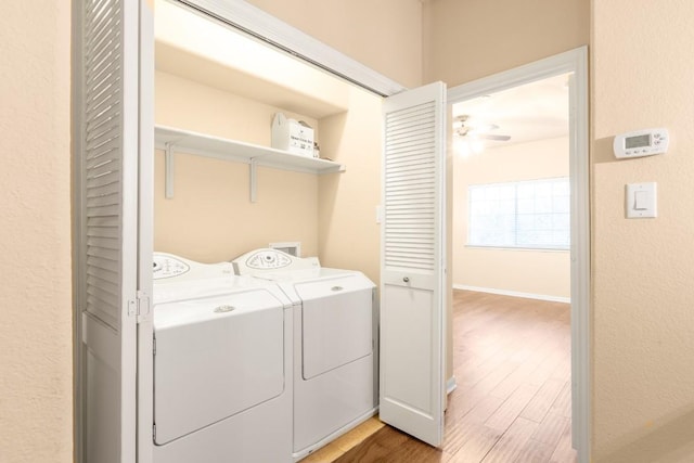 laundry area featuring wood-type flooring and washing machine and clothes dryer