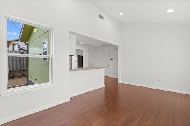 unfurnished living room featuring dark wood-type flooring