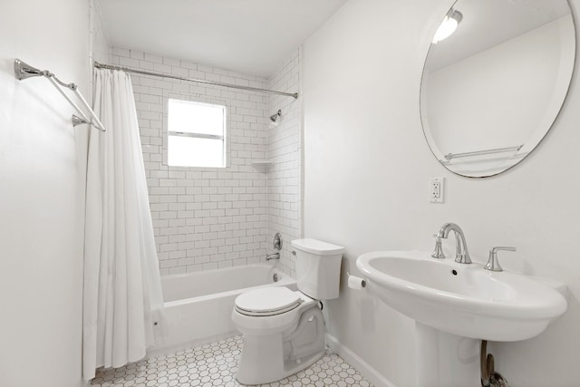 full bathroom with tile patterned floors, toilet, sink, and shower / bath combo