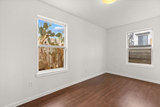 unfurnished room with dark hardwood / wood-style floors