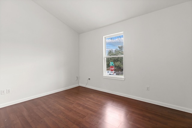 empty room featuring dark hardwood / wood-style flooring