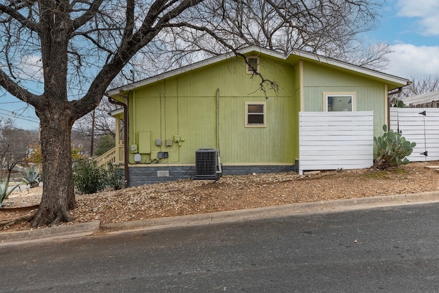 view of side of home featuring central AC