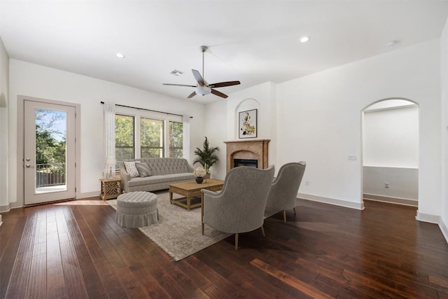 living room featuring dark wood-type flooring and ceiling fan