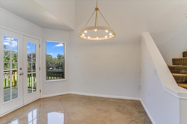 unfurnished dining area with light tile patterned floors, a chandelier, and french doors