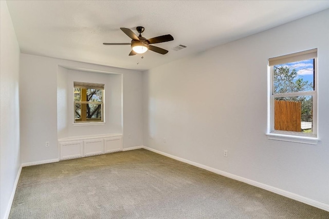 spare room with carpet and ceiling fan