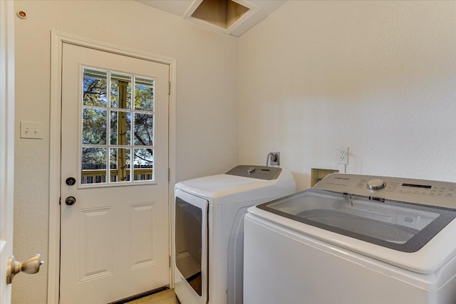 clothes washing area featuring washer and clothes dryer