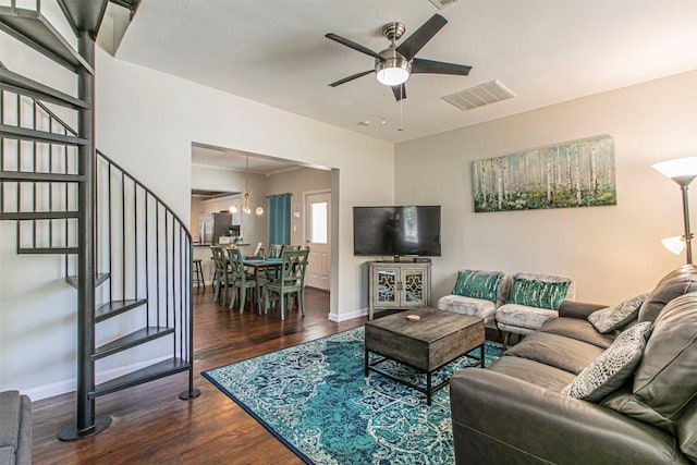 living room featuring dark hardwood / wood-style floors and ceiling fan