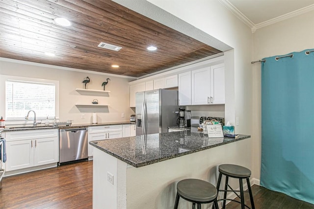 kitchen with dark wood-type flooring, sink, white cabinetry, crown molding, and appliances with stainless steel finishes