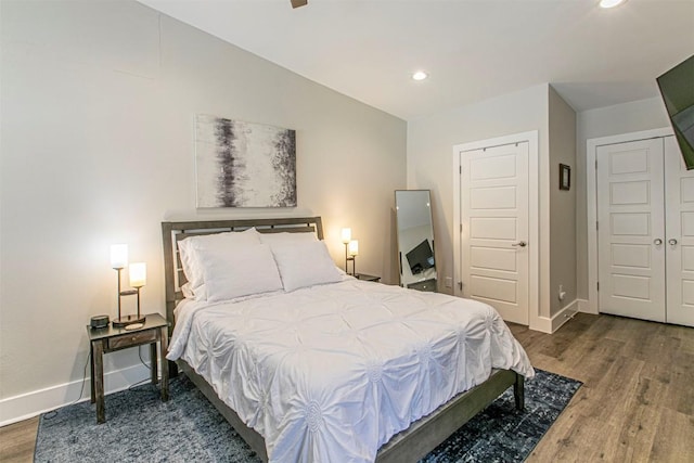 bedroom with dark hardwood / wood-style flooring and vaulted ceiling