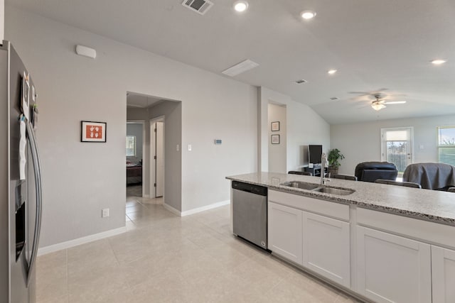 kitchen with sink, white cabinetry, ceiling fan, stainless steel appliances, and light stone countertops