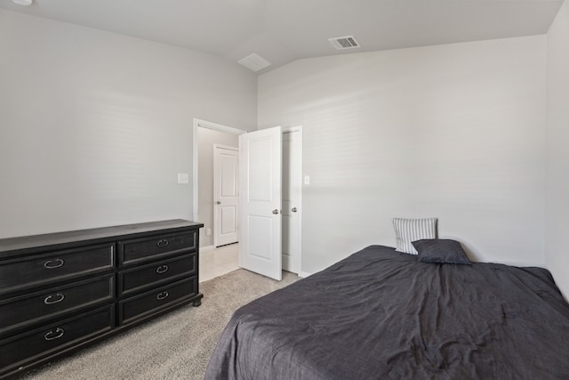 carpeted bedroom with lofted ceiling