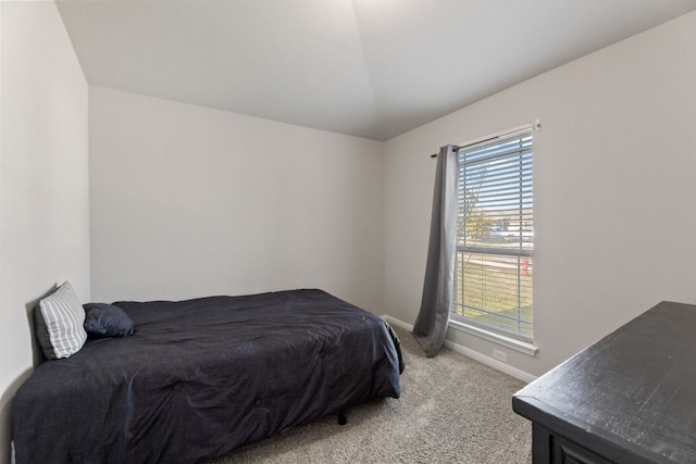 bedroom featuring lofted ceiling and light colored carpet