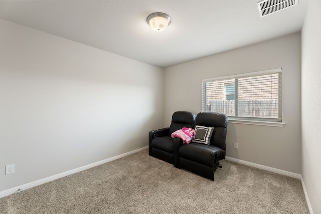 sitting room featuring light colored carpet