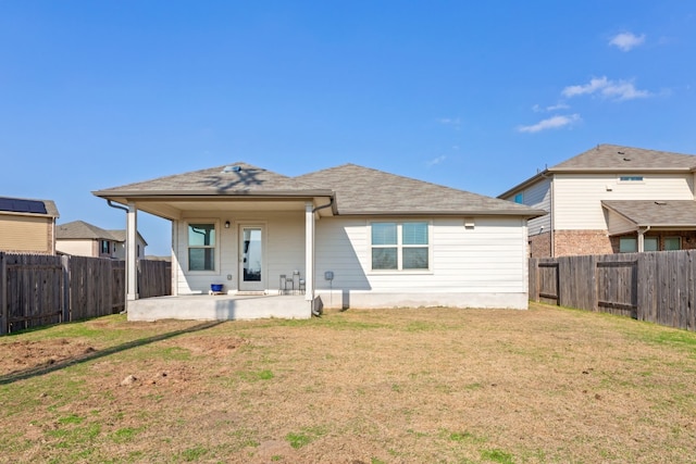 rear view of house featuring a yard and a patio area