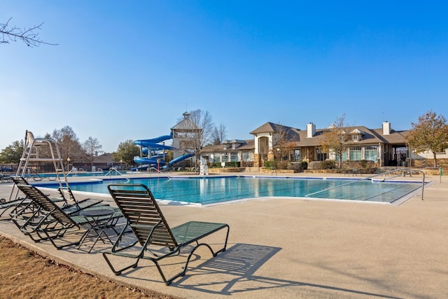 view of pool featuring a patio area and a water slide