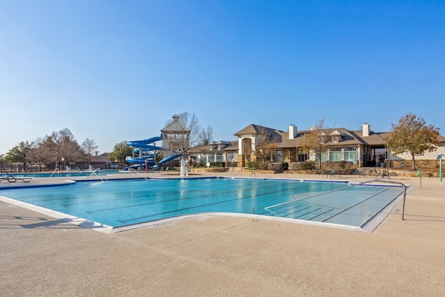 view of pool featuring a patio and a water slide