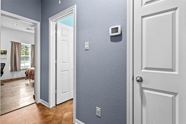 hallway featuring light tile patterned floors