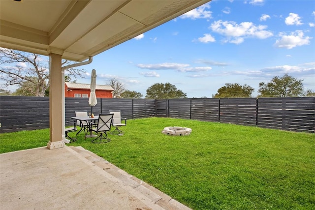 view of yard with a fire pit and a patio