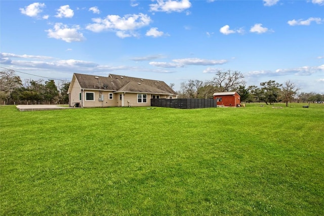 view of yard featuring a storage shed and a patio area