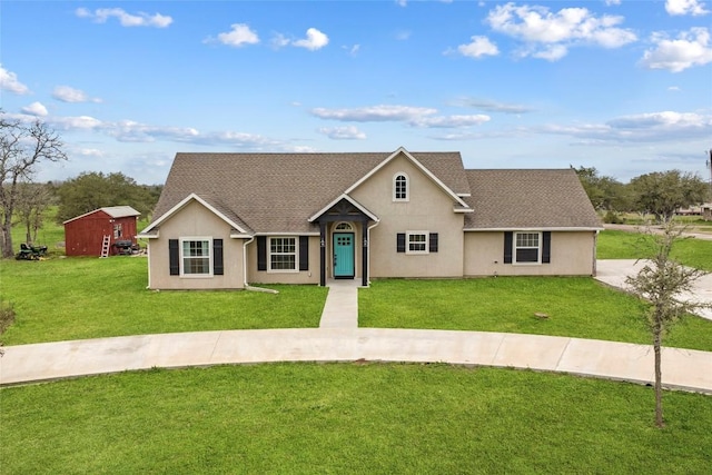 single story home featuring a front yard and a storage shed