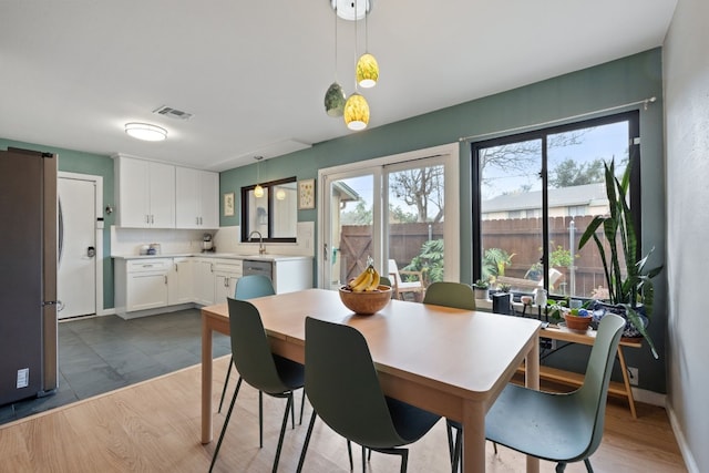 dining room with sink and hardwood / wood-style floors