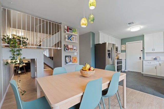 dining space with light wood-type flooring