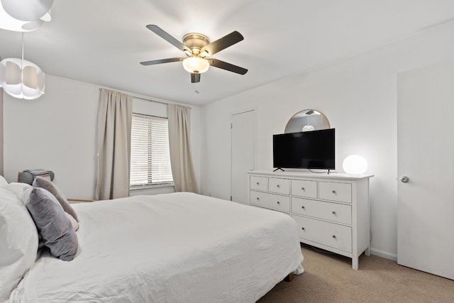 bedroom featuring light carpet and ceiling fan