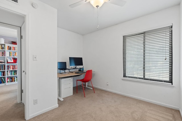 office space with ceiling fan, light colored carpet, and a healthy amount of sunlight