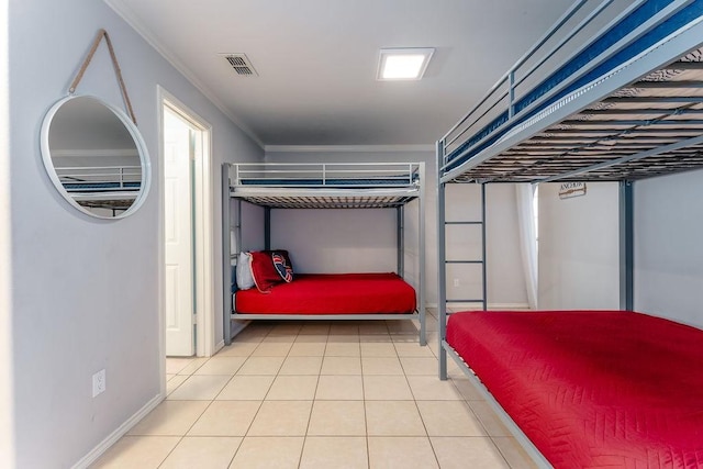 bedroom featuring tile patterned flooring and ornamental molding