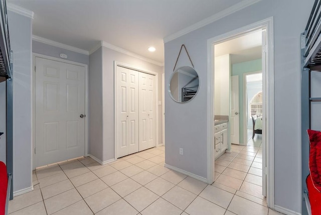 hall featuring light tile patterned flooring and crown molding