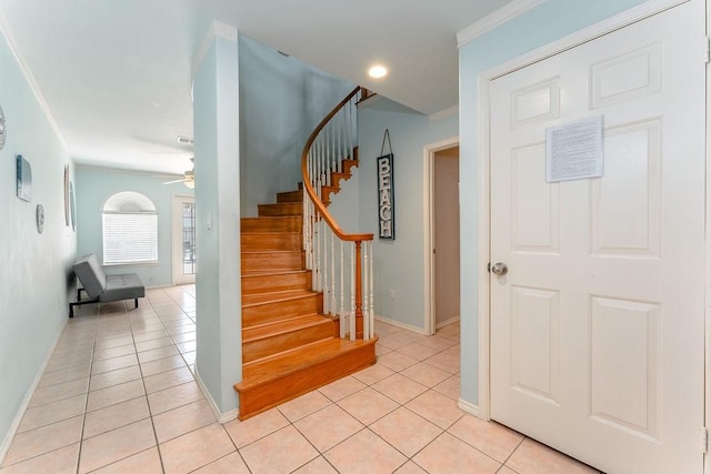 stairway featuring crown molding, ceiling fan, and tile patterned floors