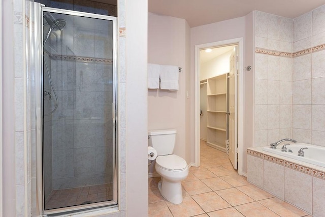 bathroom featuring toilet, tile patterned floors, and plus walk in shower