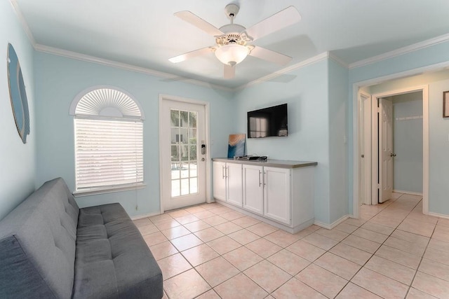 living room featuring light tile patterned floors, crown molding, and ceiling fan